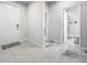 Bright and airy hallway featuring tile flooring and access to a bathroom at 3493 Lazy River Ter, Sanford, FL 32771