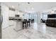 Open-concept kitchen with a large island, modern appliances, and seamless flow to the living area at 3493 Lazy River Ter, Sanford, FL 32771
