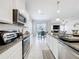 Well-lit kitchen with stainless steel appliances, granite countertops, and an open view of the living area at 3493 Lazy River Ter, Sanford, FL 32771