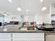 Bright kitchen featuring granite countertops, stainless steel sink, and pendant lighting at 3493 Lazy River Ter, Sanford, FL 32771