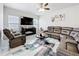 Cozy living room with a large sectional sofa, television, and area rug at 3493 Lazy River Ter, Sanford, FL 32771