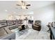 Open-concept living room boasts modern furnishings and seamlessly connects to the kitchen area at 3493 Lazy River Ter, Sanford, FL 32771