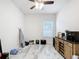 Open living room space featuring marble floors, ceiling fan, and ample natural light at 3493 Lazy River Ter, Sanford, FL 32771