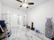 Open living room space featuring French doors, marble floors and ceiling fan at 3493 Lazy River Ter, Sanford, FL 32771