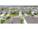 A community street featuring colorful homes with garages, green lawns, palm trees, and parked cars on driveways at 3493 Lazy River Ter, Sanford, FL 32771