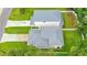 Aerial view of home highlighting roof, driveway, landscaping, and curb appeal at 350 E 2Nd Ave, New Smyrna Beach, FL 32169