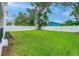 Expansive fenced backyard offering green grass and a peaceful hammock at 350 E 2Nd Ave, New Smyrna Beach, FL 32169