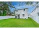 Spacious backyard featuring lush green grass and a clean white fence at 350 E 2Nd Ave, New Smyrna Beach, FL 32169