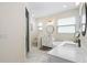 Bathroom featuring dual vanities, a soaking tub, and a tiled shower at 350 E 2Nd Ave, New Smyrna Beach, FL 32169