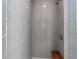 Tiled shower with a built-in wooden bench and modern fixtures at 350 E 2Nd Ave, New Smyrna Beach, FL 32169