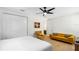 Bright bedroom featuring a yellow sofa, matching chair, and stylish ceiling fan at 350 E 2Nd Ave, New Smyrna Beach, FL 32169
