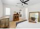 Bedroom showcasing decor, wood floors, and a glimpse into the living area at 350 E 2Nd Ave, New Smyrna Beach, FL 32169