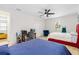Bright bedroom showcasing two beds, a modern ceiling fan, and a dedicated desk space at 350 E 2Nd Ave, New Smyrna Beach, FL 32169
