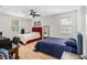Bright bedroom featuring two beds, wood floors, and a functional workspace at 350 E 2Nd Ave, New Smyrna Beach, FL 32169