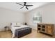 Cozy bedroom with a comfortable bed, bench, and stylish wood accent cabinet at 350 E 2Nd Ave, New Smyrna Beach, FL 32169