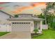 Charming home featuring a grey roof, white exterior, two car garage and beautiful lawn at 350 E 2Nd Ave, New Smyrna Beach, FL 32169