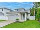 Charming home featuring a grey roof, white exterior, two car garage and beautiful lawn at 350 E 2Nd Ave, New Smyrna Beach, FL 32169