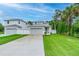 Beautiful home with a two-car garage, long driveway and manicured lawn and landscaping at 350 E 2Nd Ave, New Smyrna Beach, FL 32169