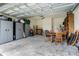 Organized garage space with ample storage, a dining set and various equipment at 350 E 2Nd Ave, New Smyrna Beach, FL 32169