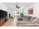 A spacious living room with a comfortable sectional sofa and a sliding glass door to the yard at 350 E 2Nd Ave, New Smyrna Beach, FL 32169
