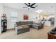Bright open-concept living room featuring a large gray sectional and modern decor accents at 350 E 2Nd Ave, New Smyrna Beach, FL 32169