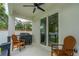 Covered patio with ceiling fan, grill, and outdoor seating, perfect for entertaining at 350 E 2Nd Ave, New Smyrna Beach, FL 32169