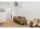 Cozy sitting area featuring a small sofa, stylish decor, and hardwood floors at 350 E 2Nd Ave, New Smyrna Beach, FL 32169