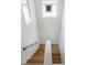Modern staircase with wooden steps and a white railing, bathed in natural light at 350 E 2Nd Ave, New Smyrna Beach, FL 32169
