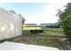 View of the community lawn area from the backyard of the unit, enclosed with a privacy fence at 3557 Brighton Park Cir, Orlando, FL 32812