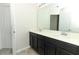 Bathroom featuring a double sink vanity and a large mirror at 3557 Brighton Park Cir, Orlando, FL 32812