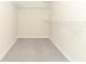 Walk in closet with carpet and white wire shelving racks at 3557 Brighton Park Cir, Orlando, FL 32812