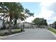 Gated community entrance with lush landscaping and a secure entry system at 3557 Brighton Park Cir, Orlando, FL 32812