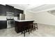 Modern kitchen featuring stainless steel appliances, dark wood cabinetry, a central island and three stools at 3557 Brighton Park Cir, Orlando, FL 32812