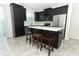 Kitchen featuring an island with stools, stainless steel appliances, and generous cabinet space at 3557 Brighton Park Cir, Orlando, FL 32812