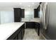 Bright kitchen with stainless steel appliances, dark cabinets, an island, and a view of the sink at 3557 Brighton Park Cir, Orlando, FL 32812
