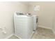 Laundry room featuring a new, white, front loading washer and dryer at 3557 Brighton Park Cir, Orlando, FL 32812