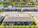 Aerial view of townhome community with a nearby lake and fountain, ample parking available at 385 Cape Honeysuckle Pl, Sanford, FL 32771