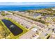 Aerial view of townhomes, apartments, a serene pond, and the community near a beautiful lake at 385 Cape Honeysuckle Pl, Sanford, FL 32771