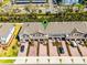 Aerial view of townhomes showing brick driveways, garages, and surrounding landscaping at 385 Cape Honeysuckle Pl, Sanford, FL 32771