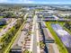 Aerial view of townhomes and apartments showcasing a community pool, pond, and surrounding greenery at 385 Cape Honeysuckle Pl, Sanford, FL 32771