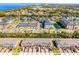 Aerial view of community apartments and townhomes, showing parking, landscaping, and a pond nearby at 385 Cape Honeysuckle Pl, Sanford, FL 32771