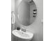 Clean bathroom with a round mirror and a stylish vessel sink at 385 Cape Honeysuckle Pl, Sanford, FL 32771
