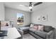 Inviting bedroom with a grey sectional couch and workspace at 385 Cape Honeysuckle Pl, Sanford, FL 32771