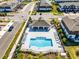 Aerial view of a pool with lounge chairs, covered pavilion, and parking in the townhome community at 385 Cape Honeysuckle Pl, Sanford, FL 32771
