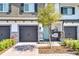 Charming townhome features a brick driveway, well-manicured shrubbery, and a porch swing at 385 Cape Honeysuckle Pl, Sanford, FL 32771
