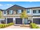 Delightful townhome exterior boasts a brick driveway, two-car garage, and a cozy front porch swing at 385 Cape Honeysuckle Pl, Sanford, FL 32771