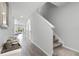Inviting hallway with wood floors, stairway, and a view to the living room at 385 Cape Honeysuckle Pl, Sanford, FL 32771