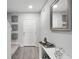 Bright hallway with wood floors and a white front door at 385 Cape Honeysuckle Pl, Sanford, FL 32771