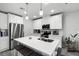 Well-lit kitchen boasts white cabinets, stainless steel appliances, and a central island with bar seating at 385 Cape Honeysuckle Pl, Sanford, FL 32771