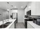 Bright kitchen featuring white cabinets, stainless steel appliances, and an island with a built-in sink at 385 Cape Honeysuckle Pl, Sanford, FL 32771
